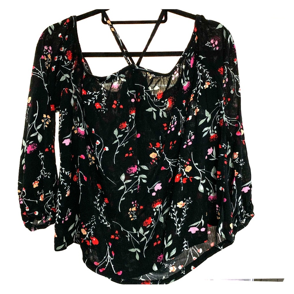 Blouse with black background and flower print.
